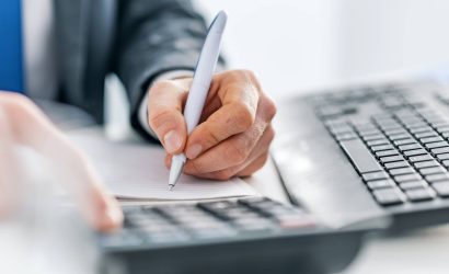 Office worker writing on notepad