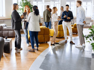 Group of employees standing in an office chatting