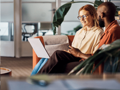 woman and man looking at a laptop screen together