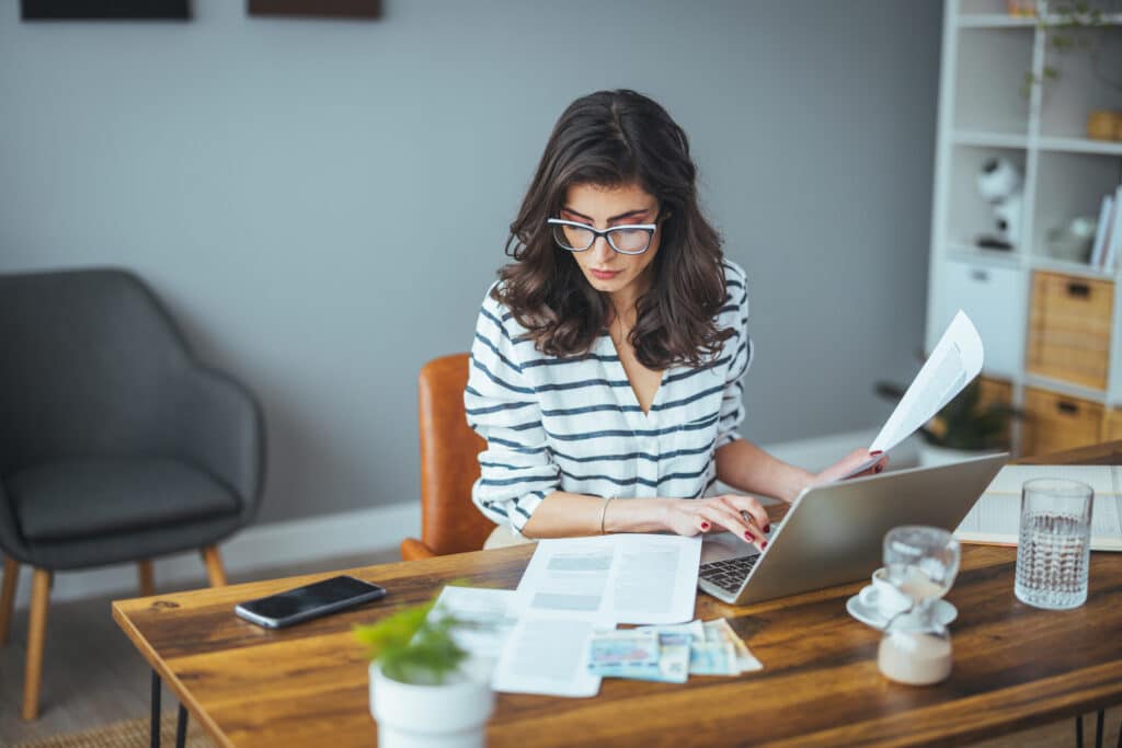 Woman reviewing payroll documents at her work desk