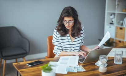 Woman reviewing payroll documents at her work desk