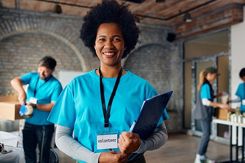 Woman in blue shirt holding a folder