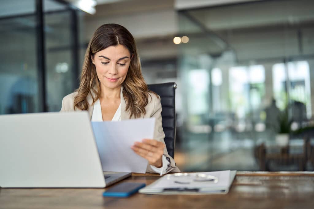 Employee at their desk reading their paycheck stub