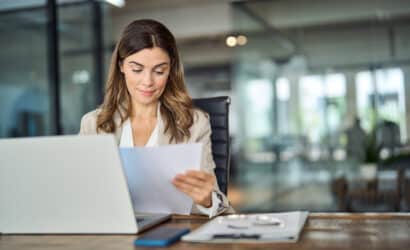 Employee at their desk reading their paycheck stub