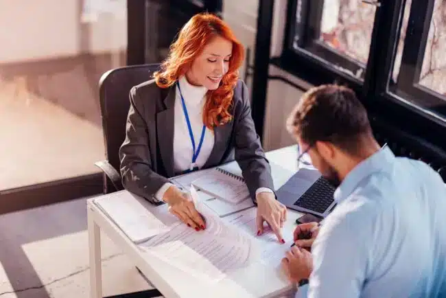 Two professionals having a conversation in a meeting