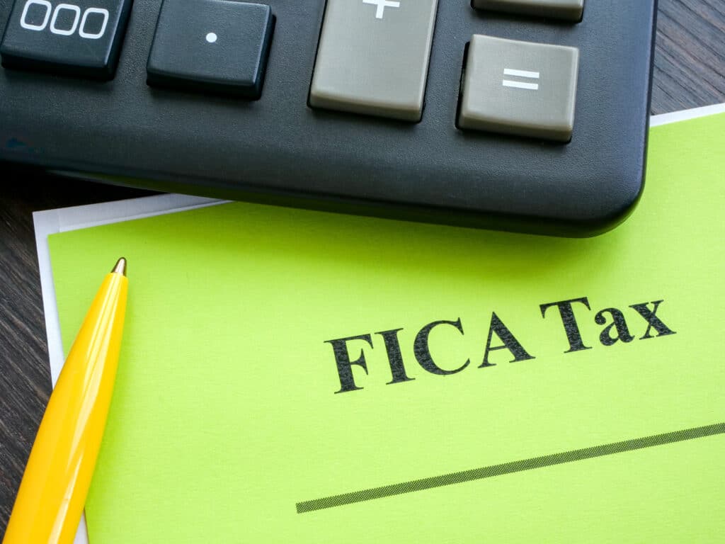 ederal Insurance Contributions Act FICA tax papers and calculator.