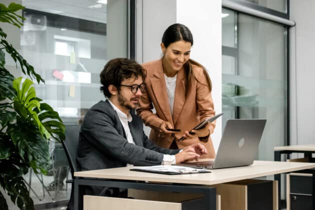 Workers looking at a laptop